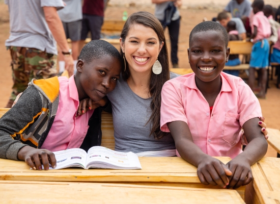 woman sitting with children in another country helping through charity